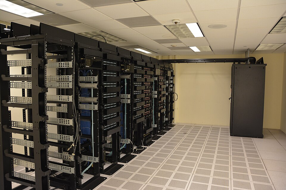 Rows of server racks inside a data center illustrating the physical infrastructure behind hyperscaler AI capital expenditure
